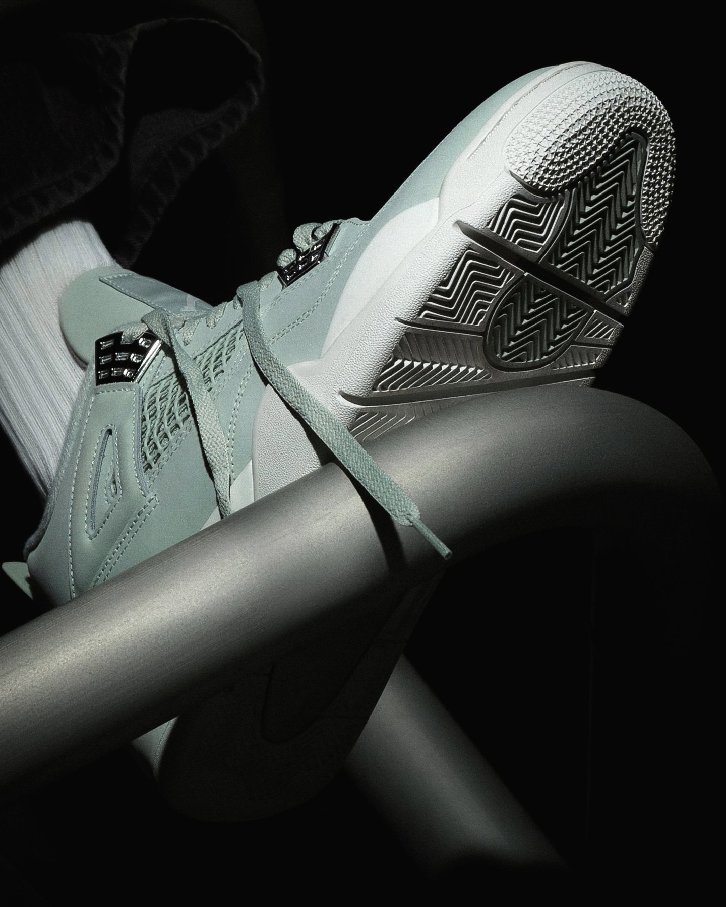 Sneaker shoot: Close detail of the mint pair resting on a metal rail